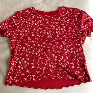 Red shirt with white little flowers.